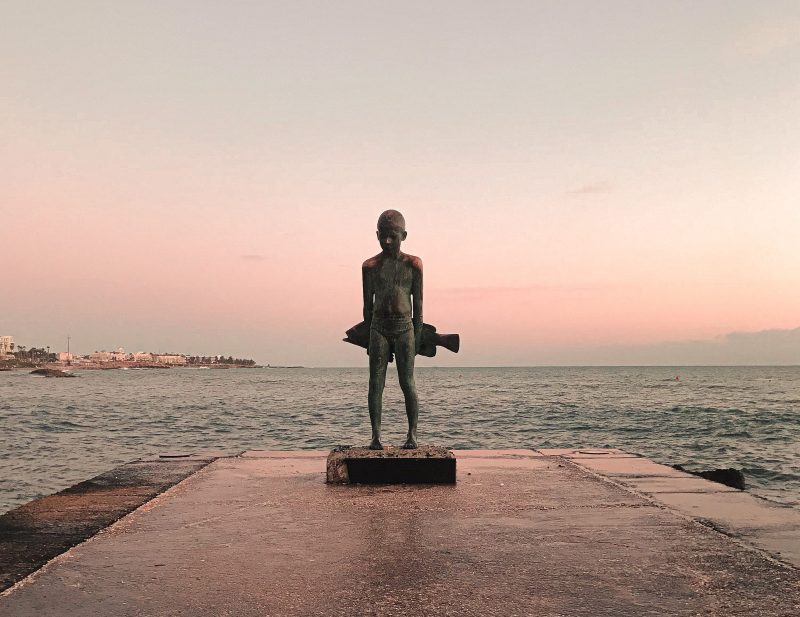 The young boy and the big fish is a bronzed sculpture of Yiota Ioannidou, located in Kato Paphos promenade, Cyprus