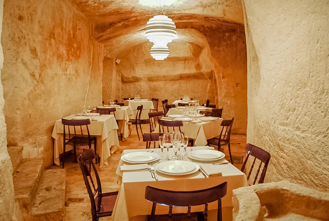 A unique setup of a cave restaurant in Matera.